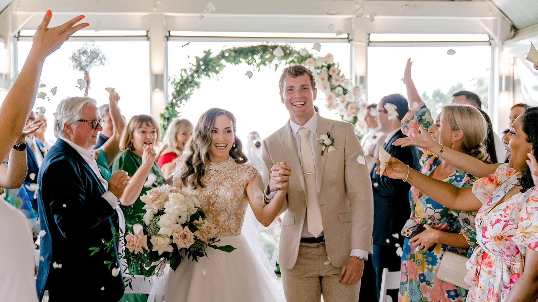 a bride and groom exit their wedding ceremony in the Pavillion at Maleny Manor.