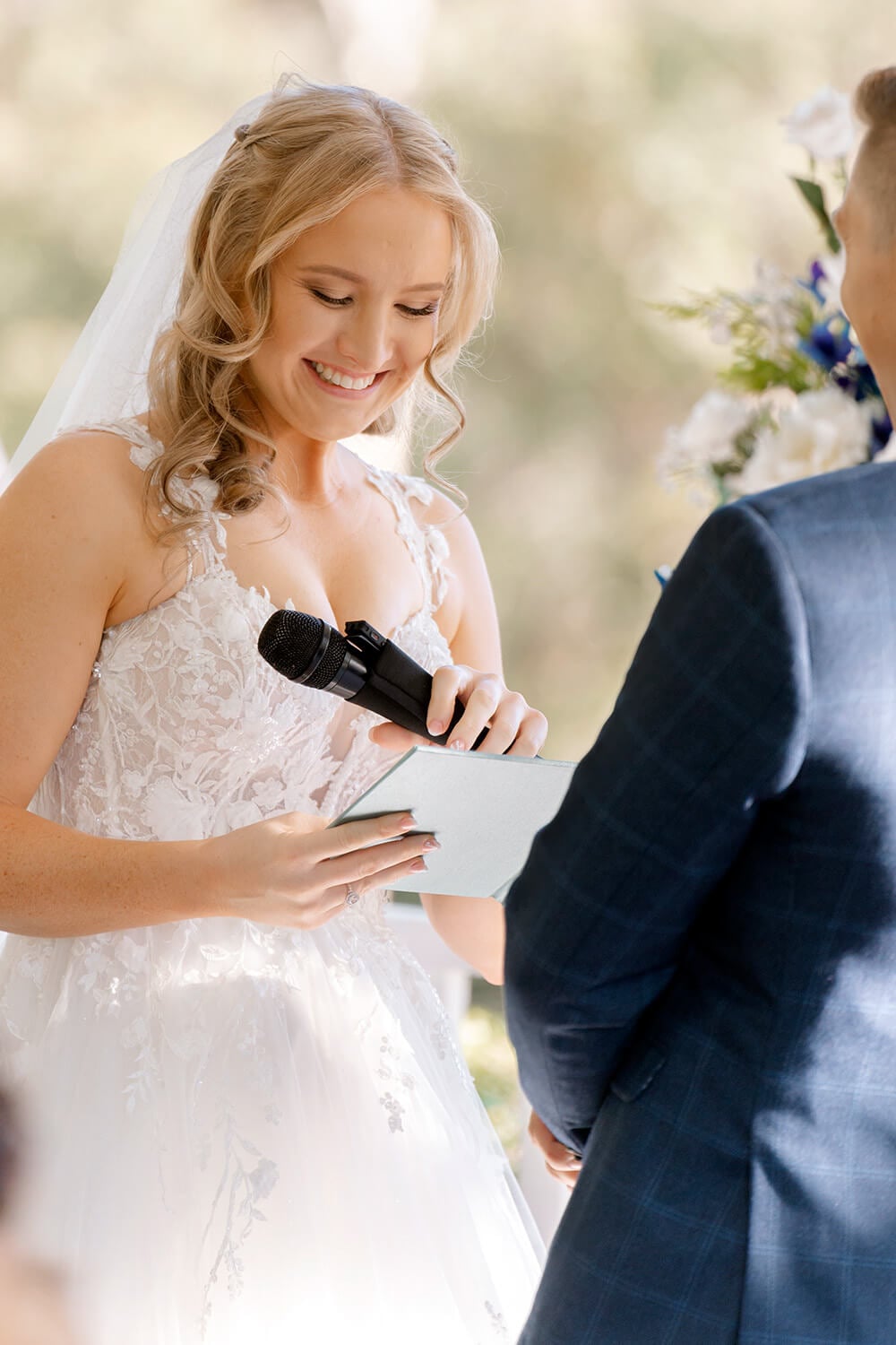 a bride reads her vows from a custom linen vow book during a wedding ceremony