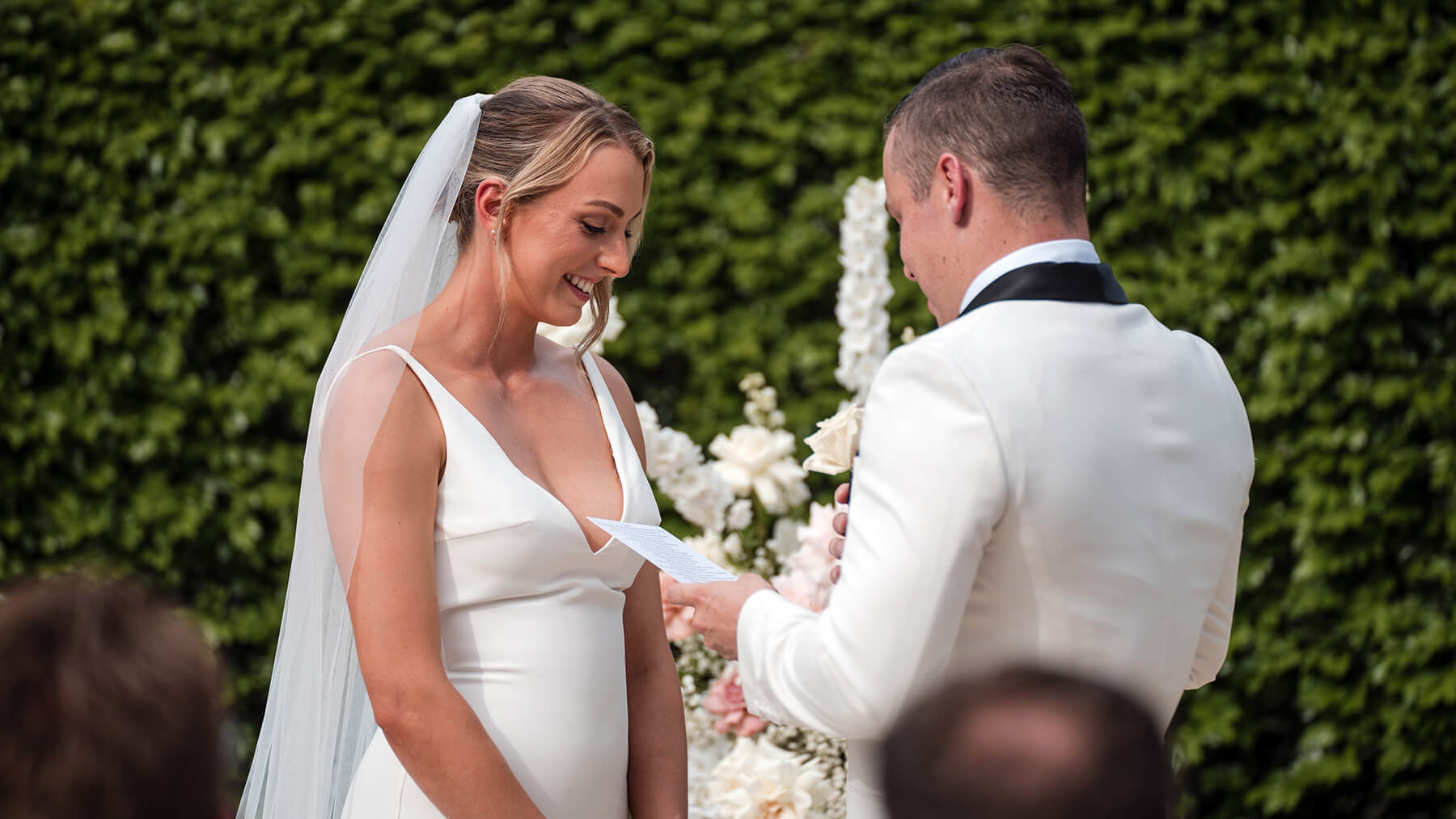 A groom reads his wedding vows to his wife at their marriage ceremony at Braeside Estate.