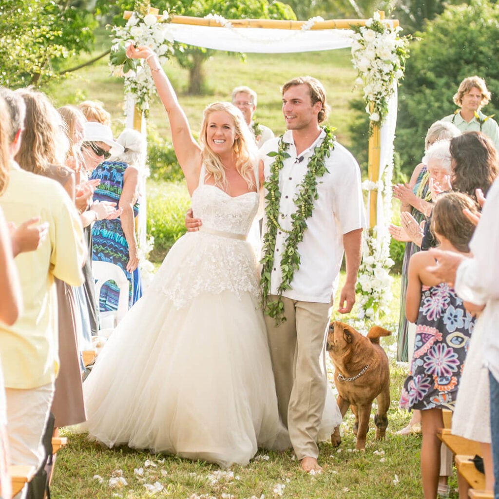 Bethany Hamilton and husband Adam cheering at they exit their wedding ceremony in Hawaii.